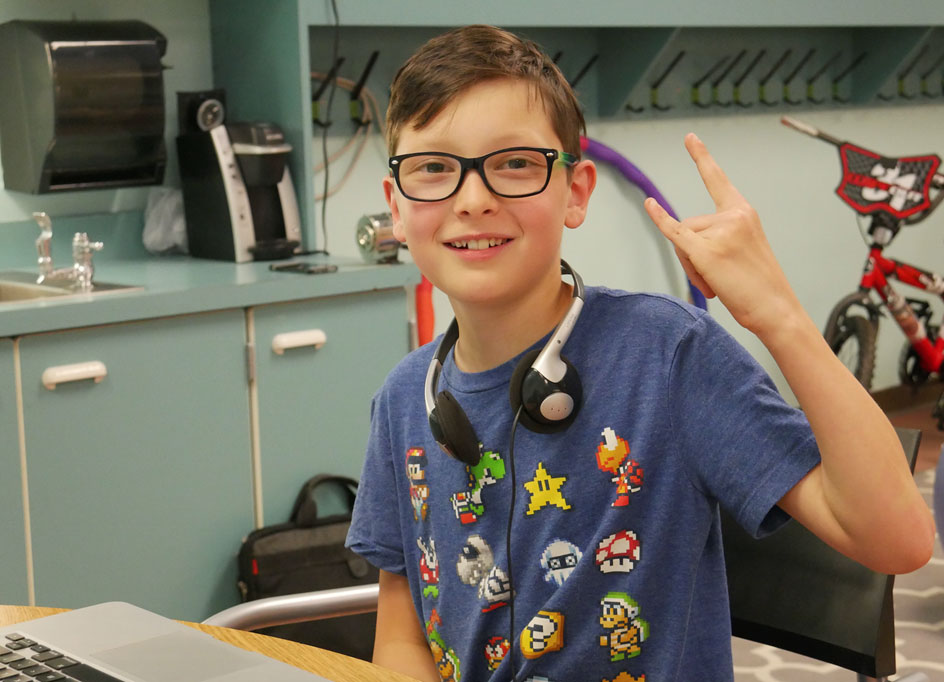 Student giving rock on hand sign